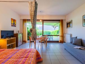 a bedroom with a bed and a table and chairs at Studio B116 by Interhome in Cissano