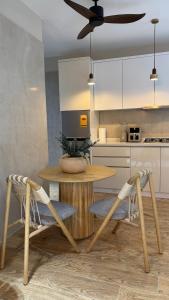 a kitchen with a wooden table and two chairs at Skylar in Trofwi