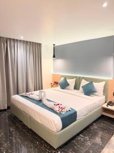 a bedroom with a large bed with flowers on it at Hotel Roop Cliff, Bhopal in Bhopal