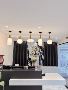 a conference room with a table and pendant lights at Hotel Roop Cliff, Bhopal in Bhopal