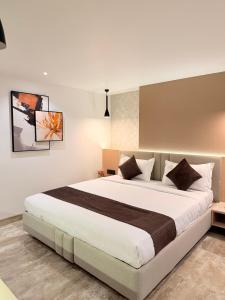 a bedroom with a large bed in a room at Hotel Roop Cliff, Bhopal in Bhopal