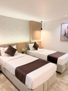 a hotel room with two beds in a room at Hotel Roop Cliff, Bhopal in Bhopal