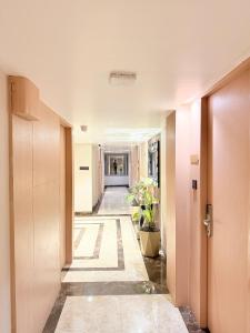 a corridor of an office building with a hallway at Hotel Roop Cliff, Bhopal in Bhopal +2 photos