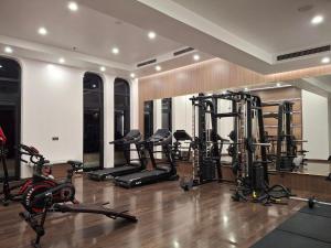 a gym with several treadmills and exercise bikes at The Dome Grand in Ninh Lão