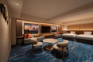 a hotel room with a bed and a couch at Okinawa Harborview Hotel in Naha