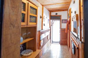 a kitchen with wooden cabinets and a hallway at Refugio con encanto en la Gomera con vistas a las montañas in Arure +16 photos