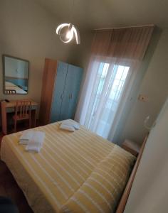 a bedroom with a bed with two towels on it at Hotel Anita in Gatteo a Mare