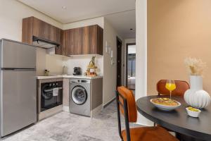 a kitchen and dining room with a table and a dishwasher at The Nest Residence by GoodMove - Gauthier Casablanca in Casablanca