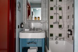 a bathroom with a sink and a bath tub at Experimental Chalet Val d'Isère in Val dʼIsère