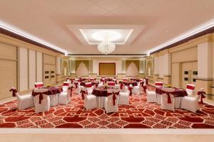 a banquet hall with tables and chairs in a room at Lemon Tree Hotel, Motihari in Motīhāri +45 photos