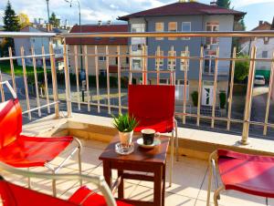 a balcony with two chairs and a table on a balcony at VerdeLuxe Sarajevo in Sarajevo