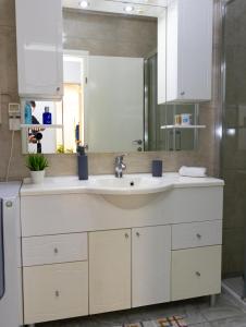 a bathroom with a sink and a mirror at VerdeLuxe Sarajevo in Sarajevo