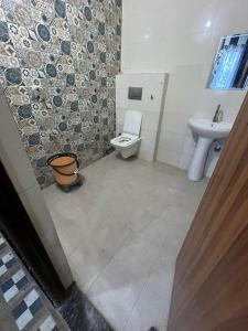 a bathroom with a toilet and a sink at Priyakant palace in Chhatikara
