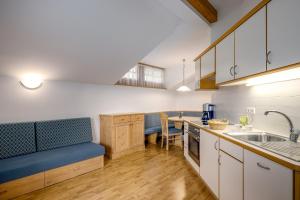 a kitchen with a blue bench in a room at Wieserhof Vals in Valles