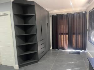 a black cabinet in a room with a window at Pegasus Peak Lodge in Drummond +15 photos