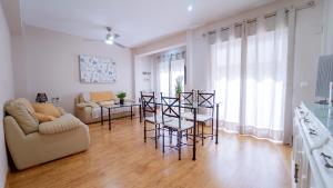 a living room with a couch and a table and chairs at DreamStay - San Vicente Ferrer Apartamento in Granada