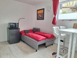 a bedroom with a bed with a red pillow on it at Apartment in Beratzhausen in Beratzhausen