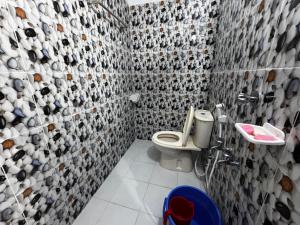 a bathroom with a toilet and a sink at Hotel Tayef Dhanmondi in Dhaka