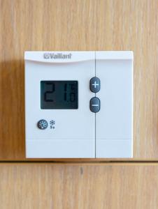 an electronic clock on a wooden wall at VerdeLuxe Sarajevo in Sarajevo