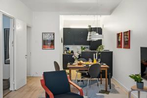 a kitchen and dining room with a table and chairs at Scandi Luxury Renovated Central Access in Helsinki