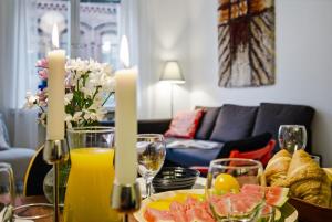 a table with a plate of food and glasses of orange juice at Scandi Luxury Renovated Central Access in Helsinki