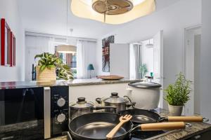 a kitchen with a stove with pots and pans at Scandi Luxury Renovated Central Access in Helsinki