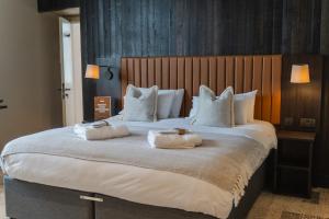 a large bed with two towels on top of it at CODE - The Court, Edinburgh in Edinburgh