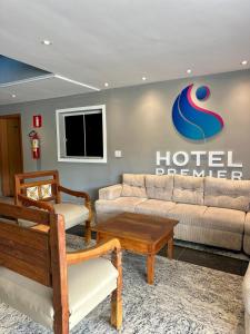 a hotel den with a couch and a table at Hotel Premier in Belo Horizonte +16 photos