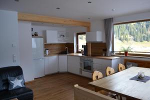 a kitchen with a table and a dining room at FamilienAppartement Waldstüberl in Kleinarl