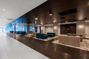 a lobby with couches and chairs in a building at Radisson Blu Resort & Conference Center, Ostróda Mazury in Ostróda