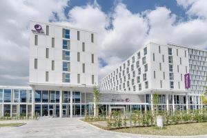 a large white building in front of a parking lot at Premier Inn Wolfsburg City Centre in Wolfsburg