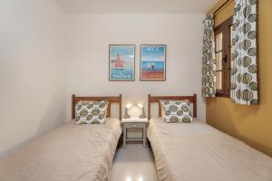 two beds sitting next to each other in a room at Viva Tenerife in Costa Del Silencio +22 photos