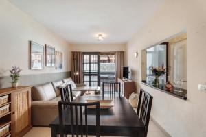 a living room with a table and a couch at Viva Tenerife in Costa Del Silencio