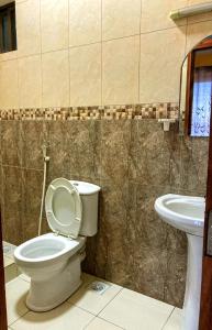 a bathroom with a toilet and a sink at TheGatsbyStyle by EcoPact in Dar es Salaam +17 photos