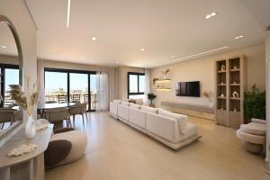 a living room with white furniture and a dining room at Stunning 3 bd penthouse with private pool - El Gouna in El Gouna
