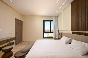 a bedroom with a large bed and a window at Stunning 3 bd penthouse with private pool - El Gouna in El Gouna +21 photos