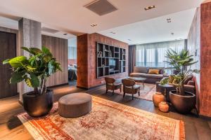 a living room with potted plants and a couch at Van Der Valk Hotel Zwolle in Zwolle