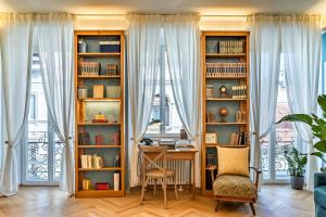a home office with a desk and book shelves at Casa Saba Trieste Luxury Apartment in Trieste