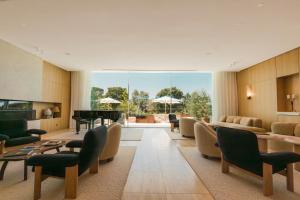 a living room with a grand piano and furniture at Domaine de Verchant & Spa - Relais & Châteaux in Montpellier