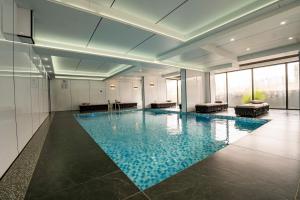 een groot zwembad in een gebouw met blauw water bij Oak Classic Residence in Nairobi