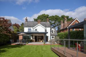 a house with a large yard with a deck at Riverview in Brockenhurst
