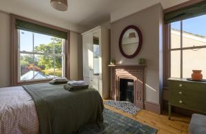 a bedroom with a bed and a fireplace at Riverview in Brockenhurst