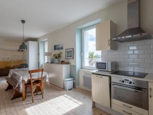 a kitchen with a table and a dining room at Appartement De Charme - Locquirec in Locquirec
