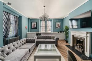 a living room with a couch and a fireplace at The Governance Apartments in Windermere