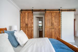 a bedroom with a bed with a wooden wall at #5A on Brassie in Lakeside
