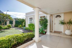 a white house with a porch and columns at #5A on Brassie in Lakeside +6 photos