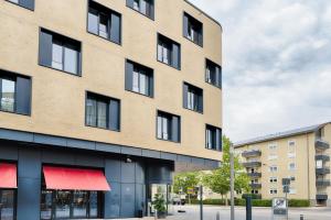 a large brick building with red awnings at Premier Inn Heilbronn City Centre in Heilbronn