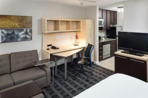 a living room with a desk and a couch at TownePlace Suites Columbia Southeast / Fort Jackson in Columbia