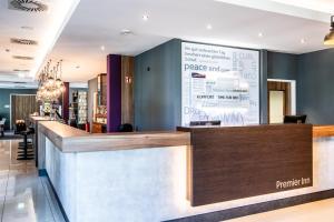 a bar in a restaurant with a large sign on the wall at Premier Inn Heidelberg City Centre in Heidelberg