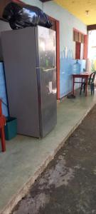 a stainless steel refrigerator in a room with a table at House Zope in Panajachel
